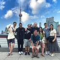 a group of people posing for a picture in front of a city