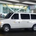 a white van parked in front of a building