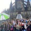a group of people standing in front of a cathedral