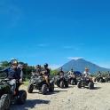 a group of people riding atvs on a dirt road
