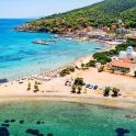 an aerial view of a beach with people in the water
