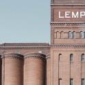 a large brick building with a lemp sign on it