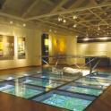 a museum with a glass floor in a room