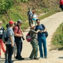 a group of people standing on a dirt road