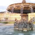 a water fountain in front of a large building