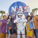 a group of people posing for a picture with an astronaut