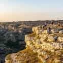 a group of people standing on the edge of a cliff