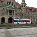 a double decker bus parked in front of a building