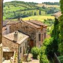 an alley in an italian village with hills in the background