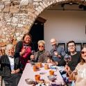 a group of people sitting at a table with wine glasses