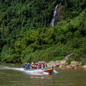a group of people in a boat on a river