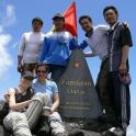 a group of people standing on the top of a mountain