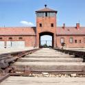 an old brick building with a gate and stairs