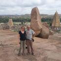a man and a woman standing in front of some rocks