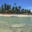 a boat in the water on a beach