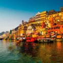 a group of buildings next to a river with boats