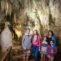 a family posing in front of a cave
