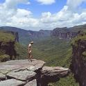 a man standing on a rock overlooking a canyon