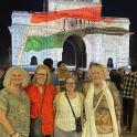 a group of women standing in front of a building