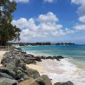 a beach with a bunch of rocks and the ocean