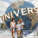 a family walking in front of the universal sign