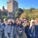 a group of people standing in front of a castle