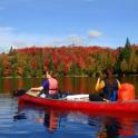two women in a red boat on a lake