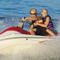 two people riding on a jet ski in the water