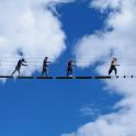 a group of people walking on a wire
