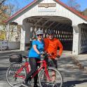 a man and a woman on a bike on a bridge