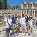 a group of people standing in front of the coliseum