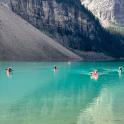 a group of people on kayaks in a mountain lake
