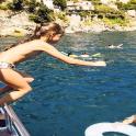 a young girl standing on a boat in the water