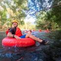 a man is sitting on a raft in a river