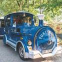 a blue train engine is parked on a street
