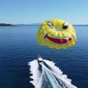 a large kite flying over a boat in the water