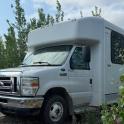 a white camper truck parked in a field
