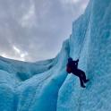 a person is climbing on an ice iceberg