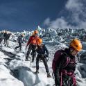 a group of people hiking on a mountain in the snow