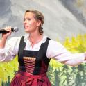 a woman is singing into a microphone