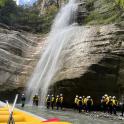 a group of people standing in front of a waterfall