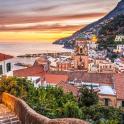 a view of the city of positano at sunset