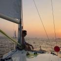 a man sitting on a sail boat in the ocean