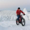 a man riding a bike in the snow
