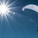 a person flying in the sky with a parachute