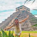 a woman standing in front of a pyramid