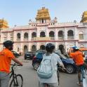 three people on bikes in front of a building