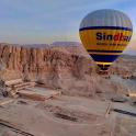 a hot air balloon is flying over a quarry