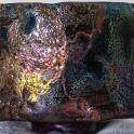 a brown object with many different colored metals