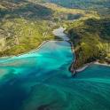 an aerial view of a beach with blue water